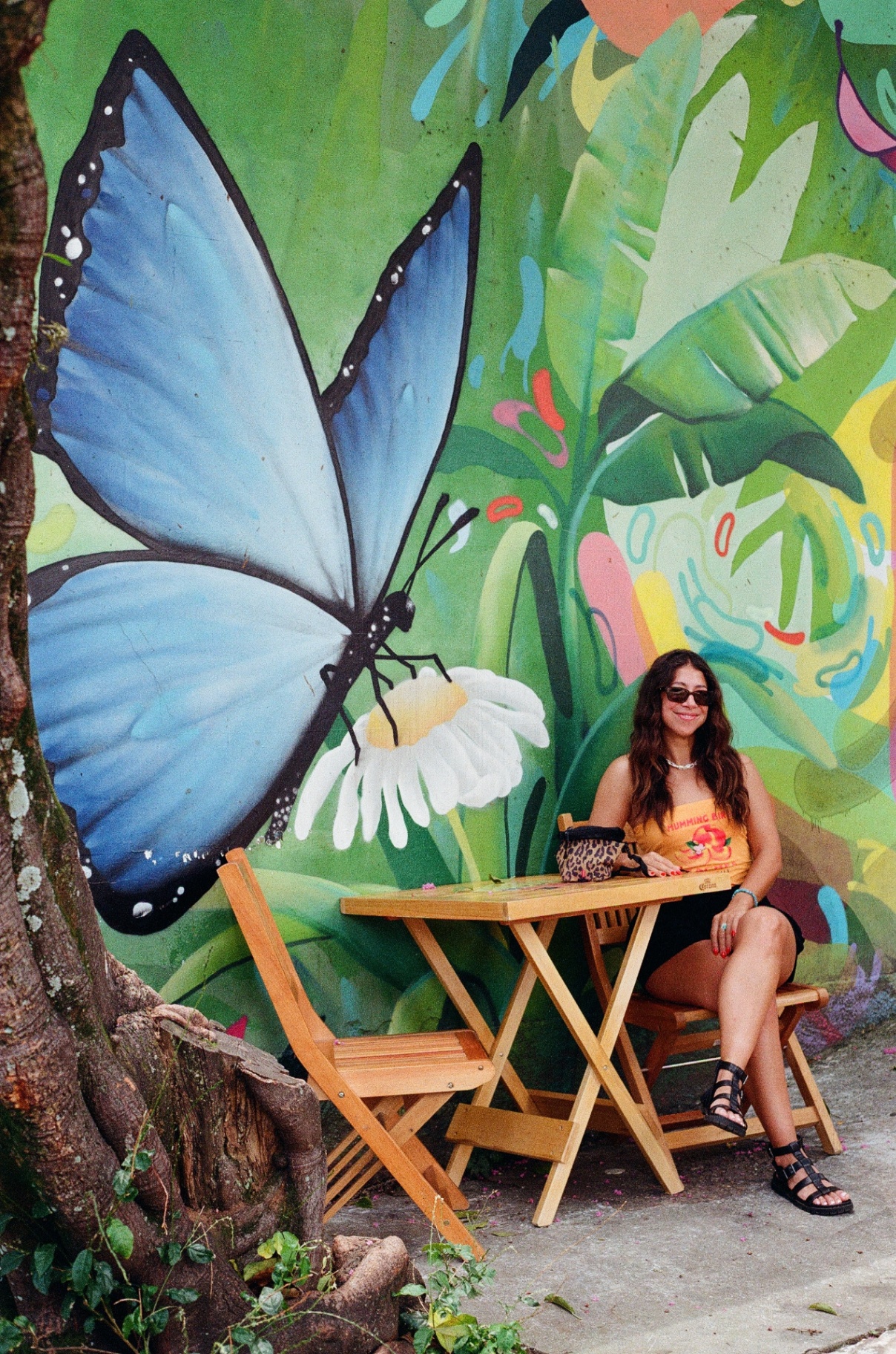 Seated by the blue butterfly mural