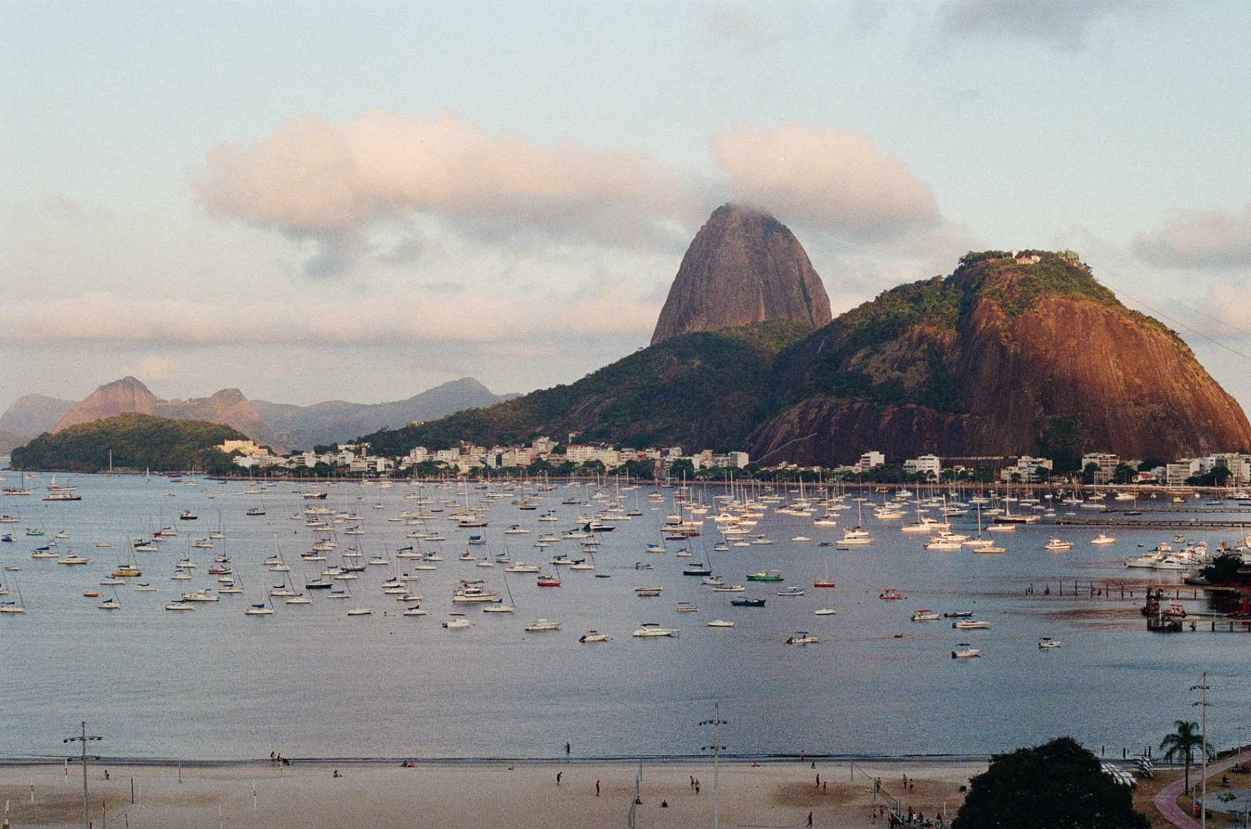 Sugarloaf Mountain and Botafogo Bay at golden hour, dotted with sailboats