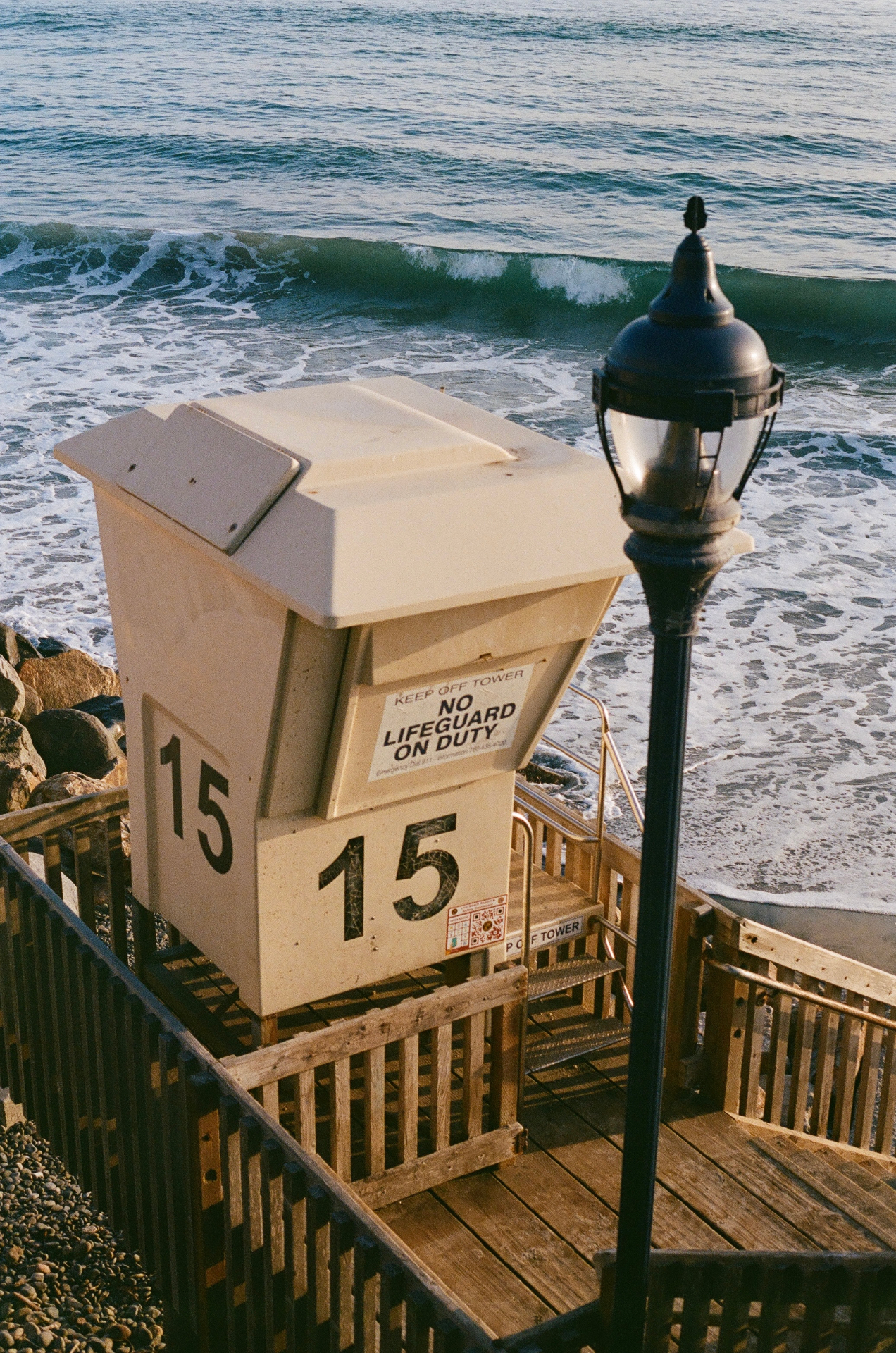 Lifeguard tower number 15 above the surf on a sunny California beach