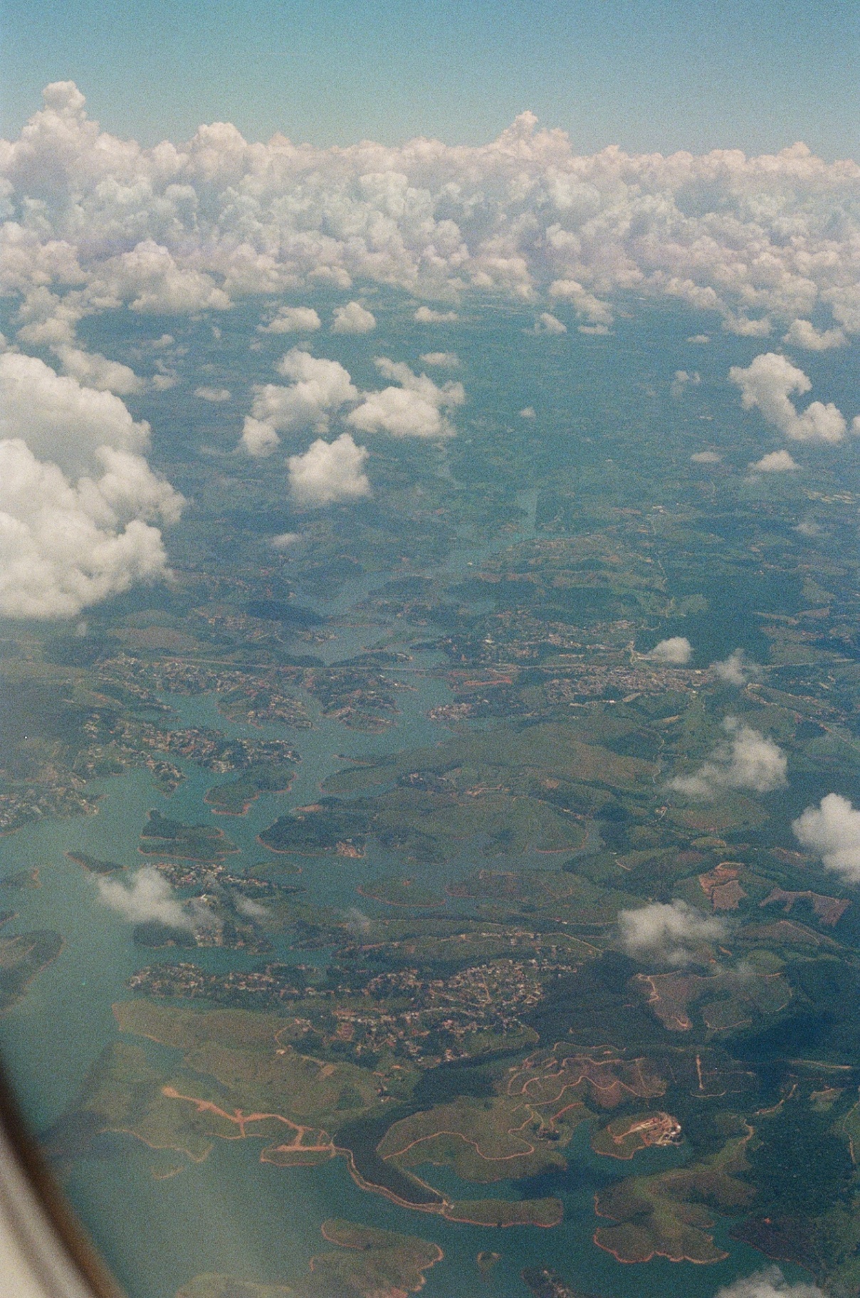 Aerial view of the Brazilian coastline through scattered clouds