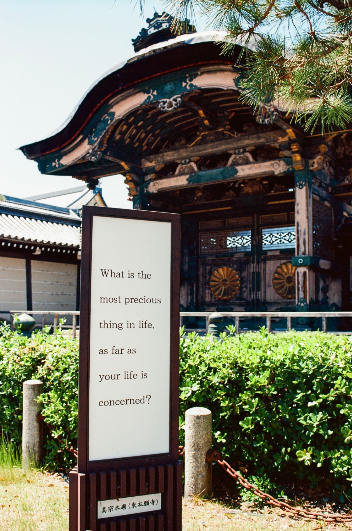 Sign reading 'What is the most precious thing in life, as far as your life is concerned?' in front of Higashi Honganji temple in Kyoto