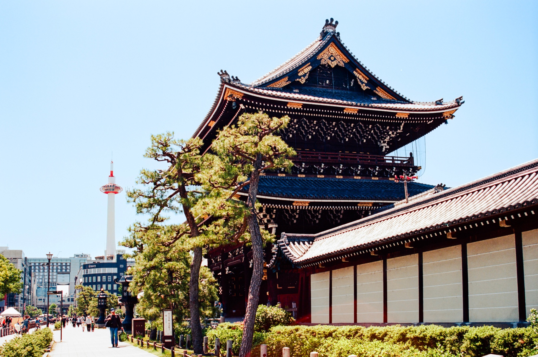 Higashi Honganji temple gate with Kyoto Tower rising in the distance
