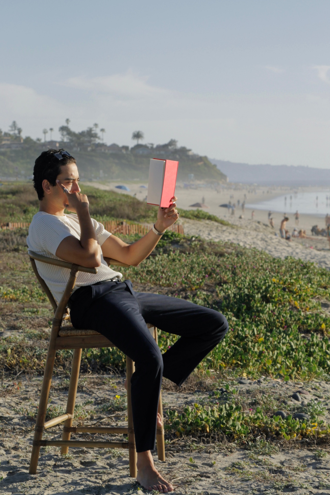 Christian reading on the bluff above the beach