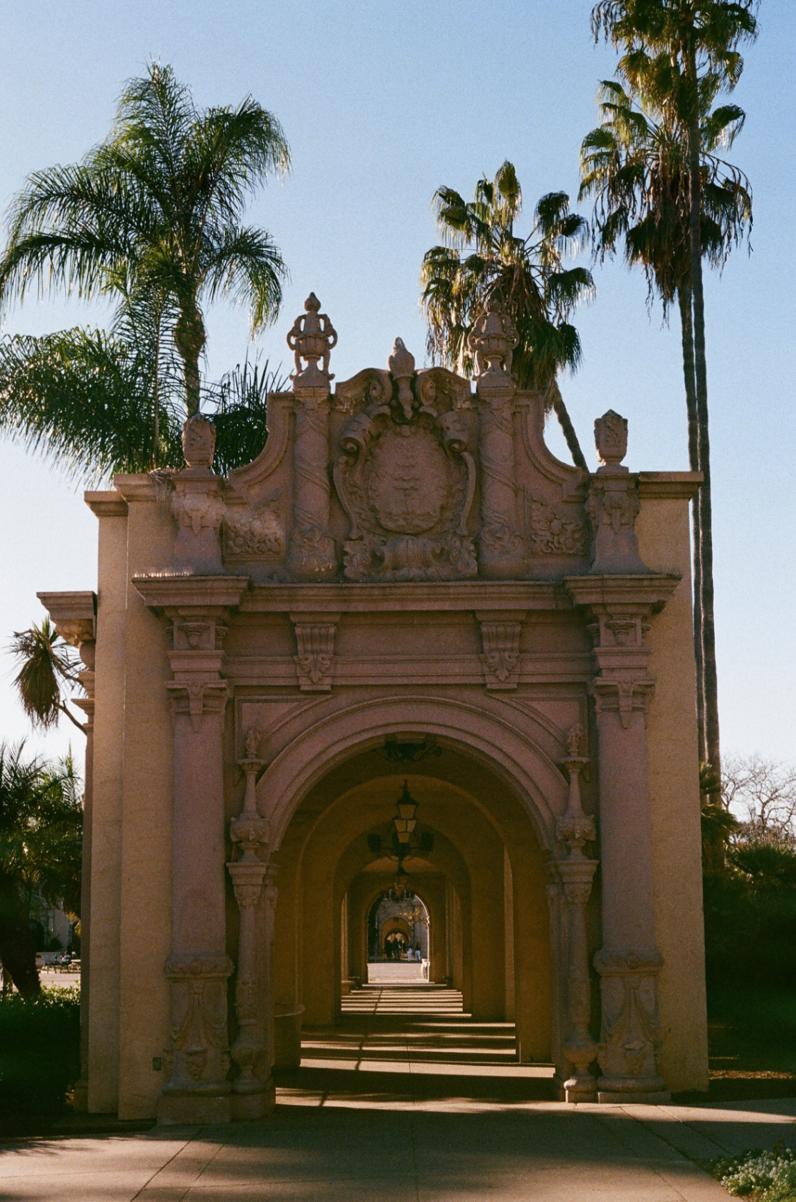Ornate Spanish Revival archway flanked by palms at Balboa Park, San Diego