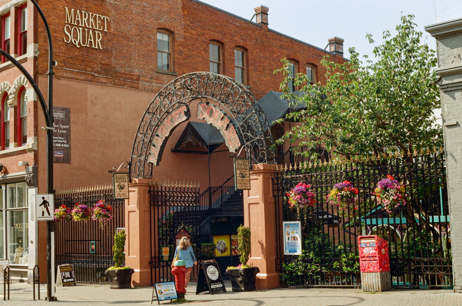 Wrought iron Market Square archway with hanging flower baskets in Victoria's Old Town